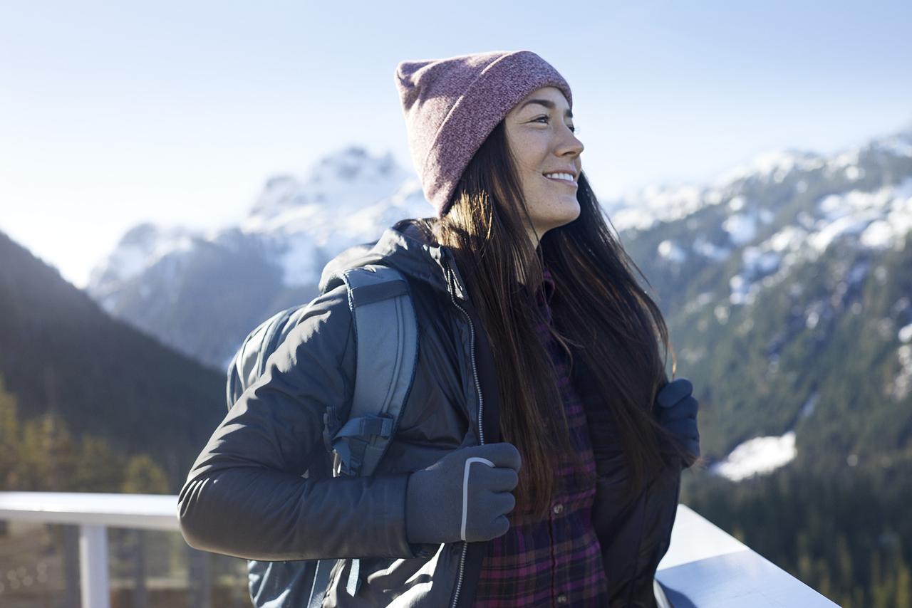woman wearing Gore gear with scenic mountains in the background